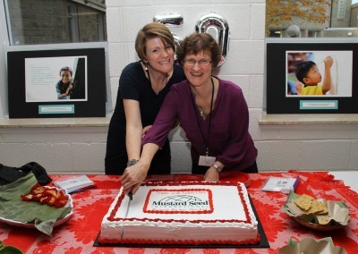 Our Canadian Director, Lucie Howell, and office administrator, Erin Hartley-Asare, cutting the cake in celebration of MSI Canada's 50th anniversary! —